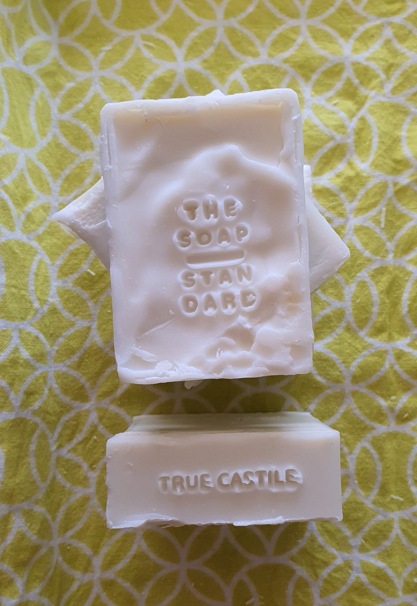 True Castile Soap Bars on yellow and white background.