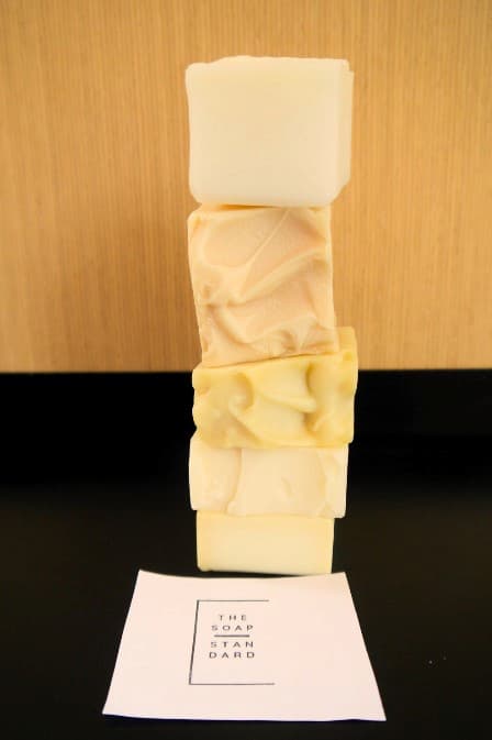 Stack of 5 white, cream and yellow coloured soap bars