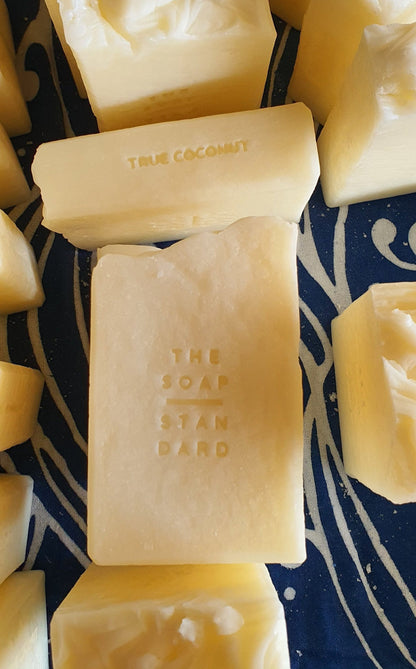 True Coconut Soap Bars on a blue and white background